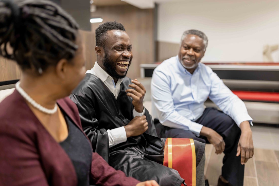 Man sitting with friends laughing.
