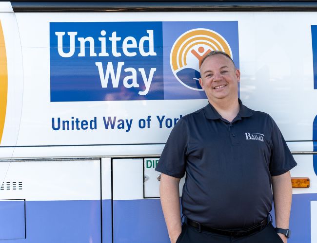 Man standing next to bus