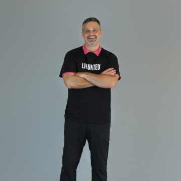 man standing with his arms cross in black live united shirt