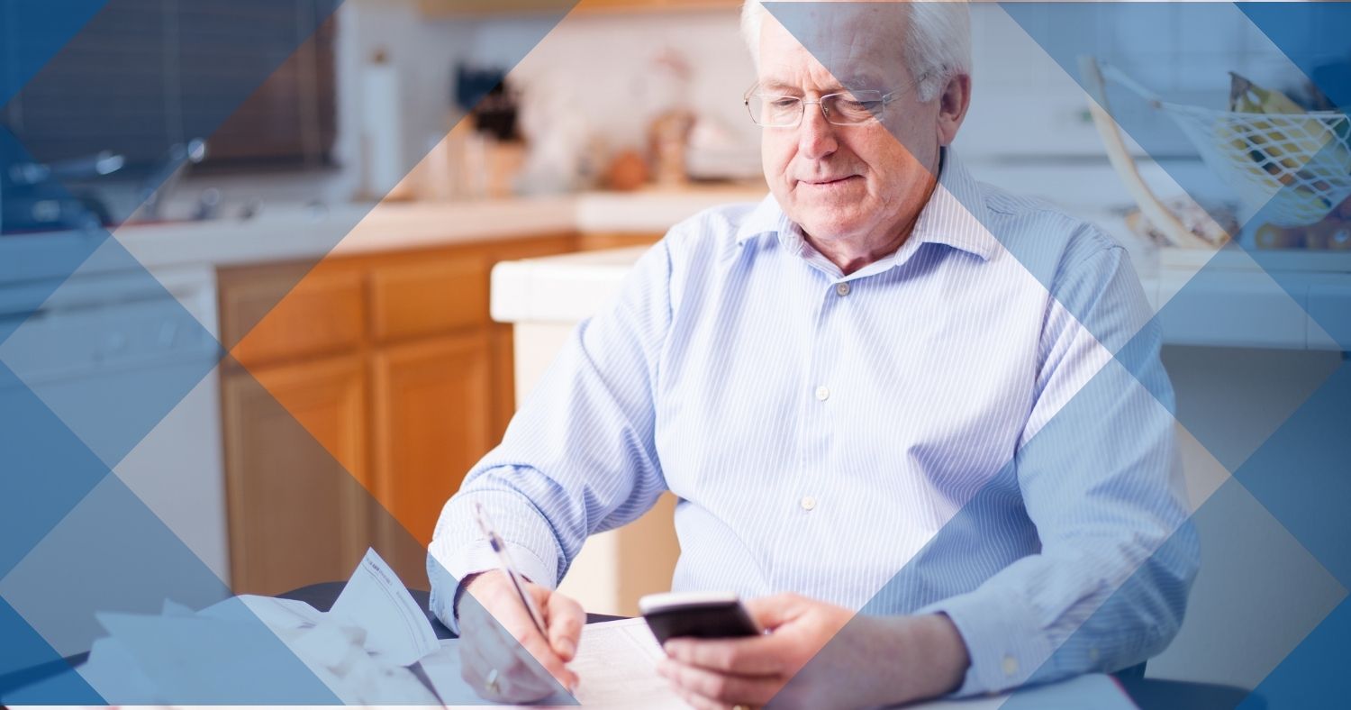 elder man looking stressed while filing taxes