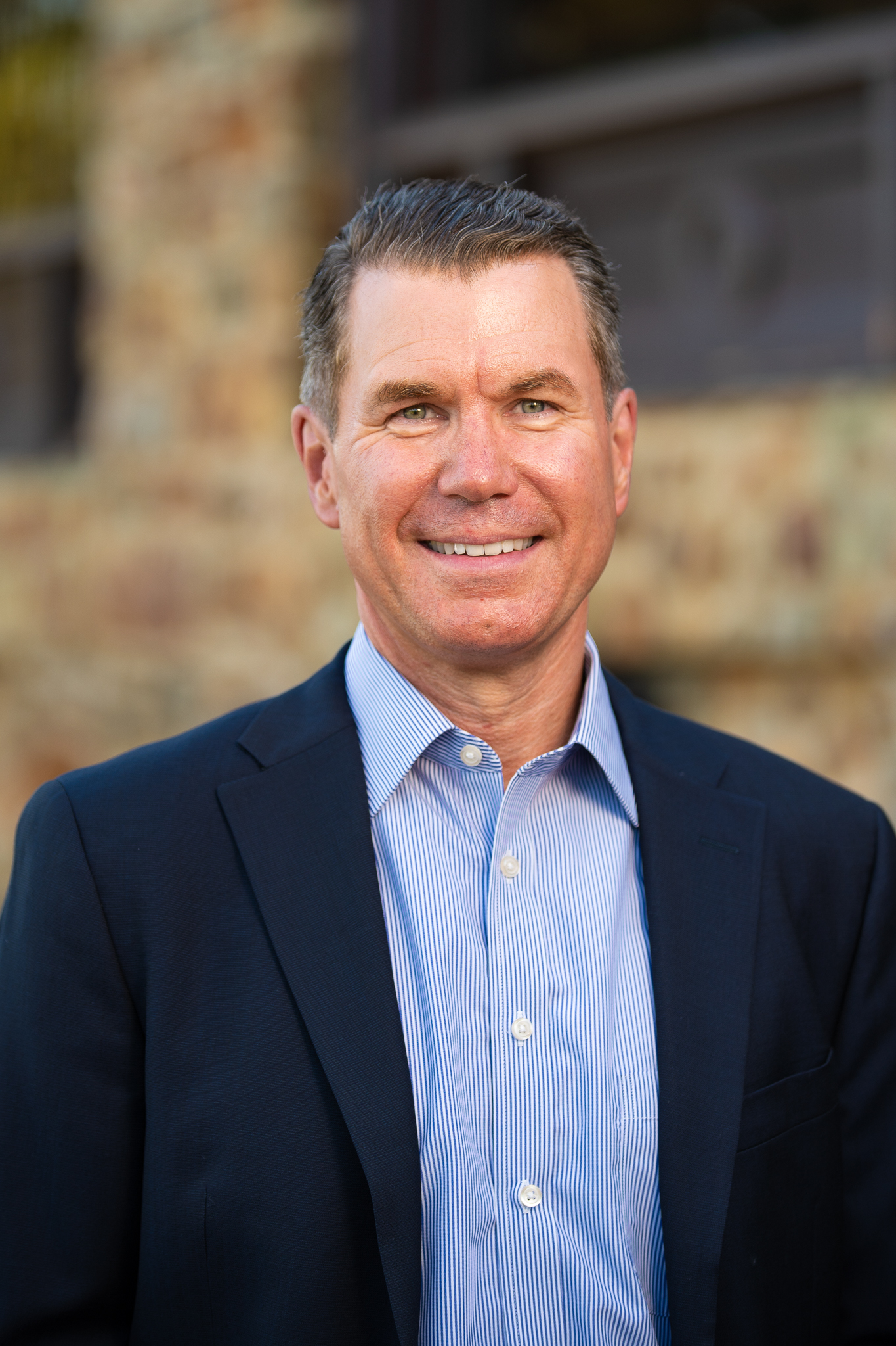 white man smiling in a suit