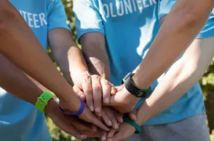 People putting there hands in together.