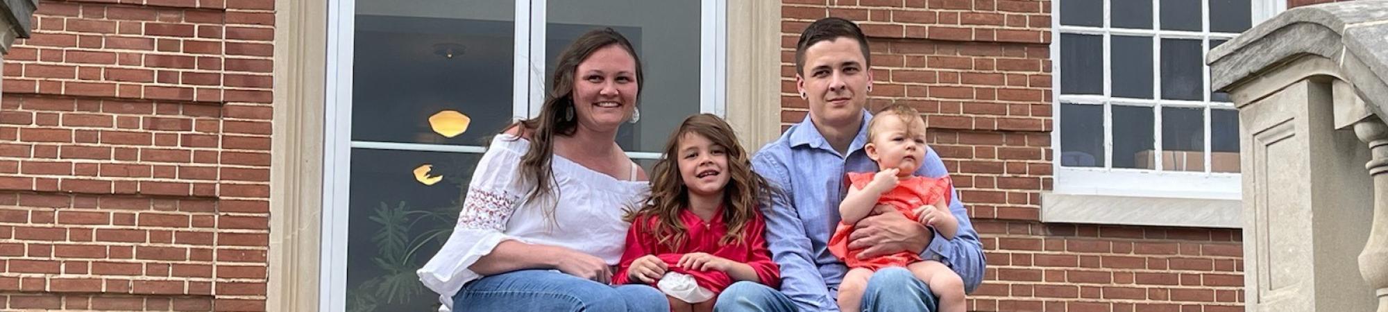 family sitting on steps